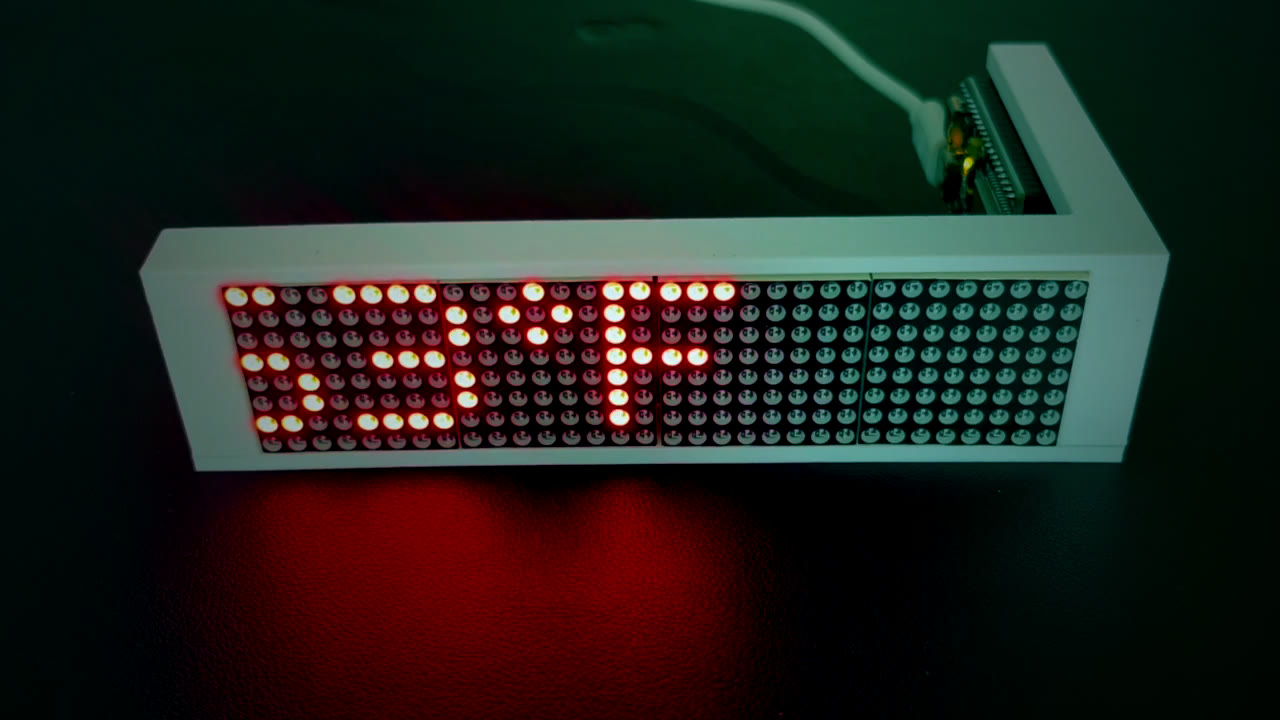 The LED Ticker on a desk, its red dot-matrix display showing a countdown timer.